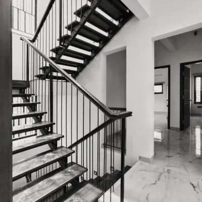 This floating metal staircase is a sculptural, light-filled entity that gives the home its life. Instead of a bulky structure, we designed it to be a focal point that is both functional and artistic.