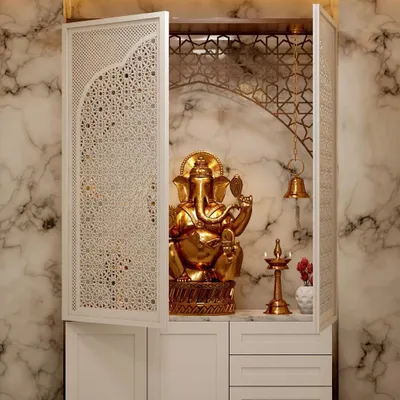 An elegant pooja unit I designed with intricate jali-work doors. The interior features a marble-finish back panel and warm backlighting to create a divine ambiance.