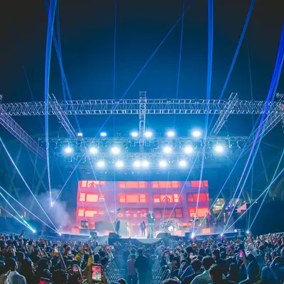 A wide-angle view of the Akon India Tour stage. This shot captures the full production, including the massive lighting truss, laser show, and the huge crowd with their phones up, showcasing the scale of the event we delivered.