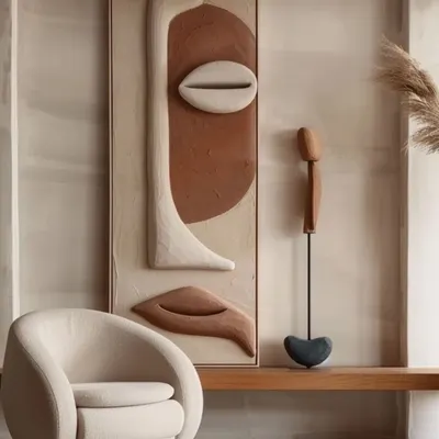 Art is the soul of a room. This textured, sculptural wall art in earthy tones serves as a powerful focal point. Paired with a beautifully curved armchair, it creates a corner that feels like a private art gallery, adding sophistication and personality to the home.