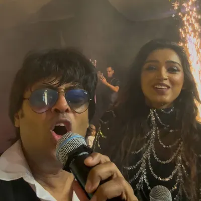 A selfie with my co-singer right before hitting the stage, with the pyrotechnics going off behind us. The calm before the storm!