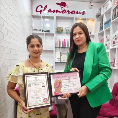 Another student proudly displaying her government-approved certificate alongside her course completion certificate. She is now a certified nail technician, ready for new opportunities.