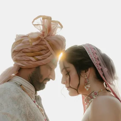 A moment of pure stillness against the light. This close-up of the couple, their foreheads touching, captures the deep, unspoken connection that is at the heart of every love story.