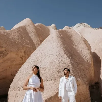 Dressed in white against the unique rock formations of Cappadocia, Turkey, Kashish and Simran create a striking, high-fashion portrait. This is an example of how we use dramatic landscapes to create editorial-style pre-wedding images.
