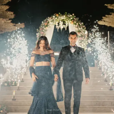 A grand entrance for the couple at their reception, walking through a tunnel of sparklers held by their loved ones. I orchestrate these high-impact moments to create unforgettable memories.