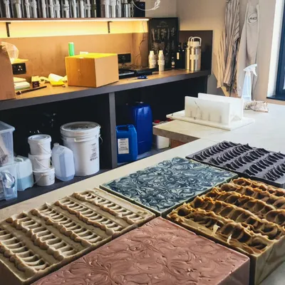 This is what production for my wholesale partners looks like. Multiple loaves, each with a unique design and formulation, are setting in my studio. I can handle bulk orders while ensuring every single bar meets my high standards for quality.