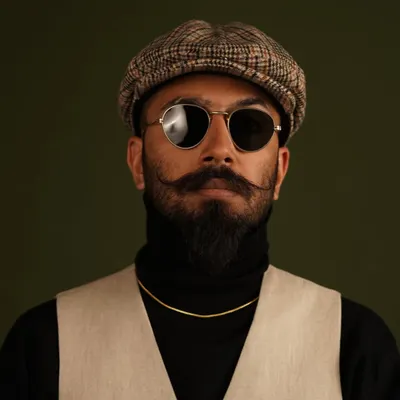 A direct and confident portrait from a studio session. This style is effective for classic menswear, eyewear promotions, and portfolio headshots that require a strong presence.