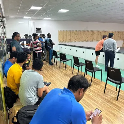 A corporate group listens to a safety briefing before their team shooting event begins. We ensure every session starts with clear instructions to create a secure and enjoyable environment for all participants.