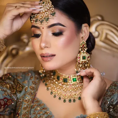 Completing the bridal look with a set of elegant, long nails. A subtle French manicure design like this complements the intricate details of the outfit and jewellery without overpowering them.