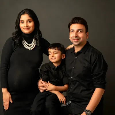 A beautiful family portrait with everyone dressed in classic black. Our fitted maternity dress ensures you look elegant while celebrating with your loved ones.