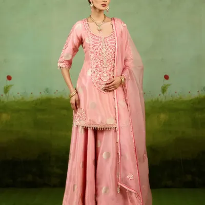 This pink sharara set is both playful and refined. The fluid lines of the sharara pants combined with the intricately embroidered kurta create a look that brings modern ease to festive elegance, perfect for a sangeet or mehendi.