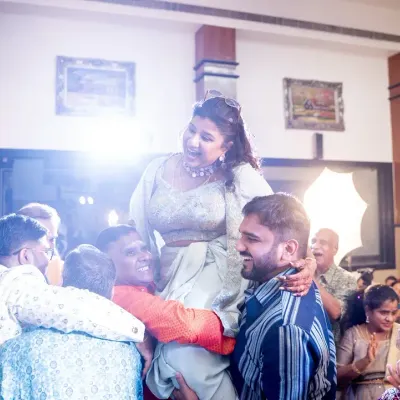 The bride being lifted up by her friends and family in a moment of pure celebration. These are the high-energy, unforgettable moments I strive to create.