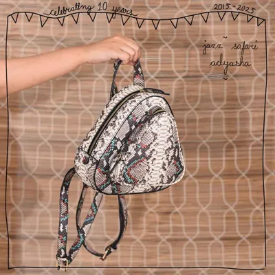 Our Adyasha backpack, reimagined in the bold Jazz Safari print. This exotic snakeskin-effect leather is created through a multi-step process of embossing and foiling on real leather, making each piece a unique statement.