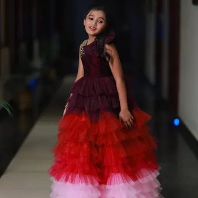 This is a beautiful color-layered gown I designed for a 10th birthday. It transitions from wine to red to pink, with sparkling details on the bodice.