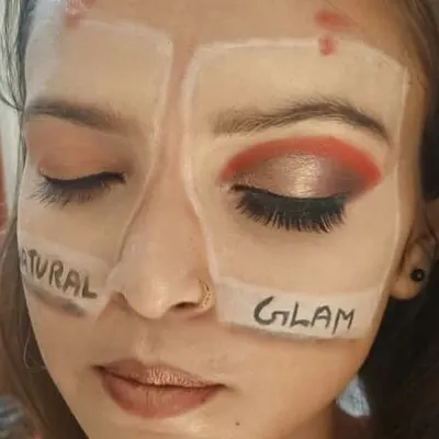 This image shows our hands-on training method. Here, a student practices two different styles on one face, learning the techniques for a soft, natural look versus a dramatic glam look. This is how we build practical skills and muscle memory.