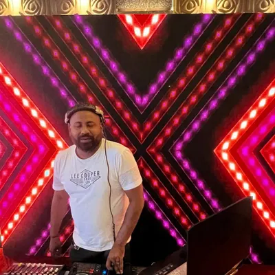 At the console during a Goan wedding reception, with a custom LED backdrop. I make sure my setup looks as good as it sounds, adding to the overall ambiance of your event.