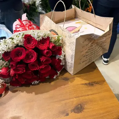 I can easily combine your flower order with a fresh cake for a complete celebration package. This is a red rose bouquet ready to be delivered with a birthday cake in Ghaziabad.