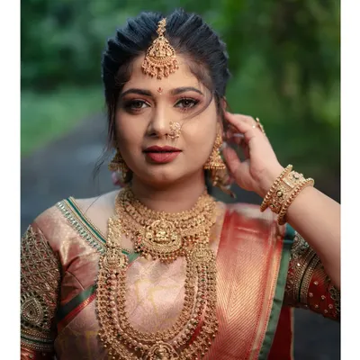 A breathtaking portrait of a bride in a traditional South Indian look. The focus is on her intricate temple jewellery and flawless makeup, capturing the elegance and heritage of her style.