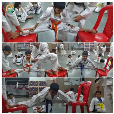 Young students work diligently on their splits with the help of chairs. We use various tools to help students safely achieve their flexibility goals.