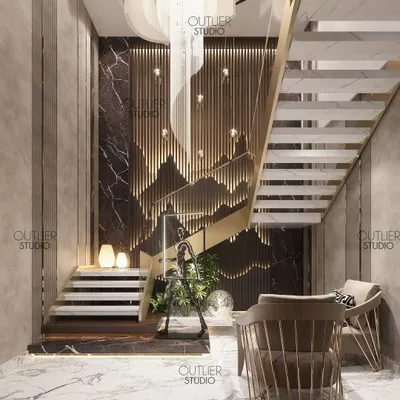 A sneak peek of the grand entrance lobby to our triplex masterpiece. A dramatic chandelier hangs above a sculptural staircase, with a feature wall of backlit wood panels creating a mountain-like silhouette.