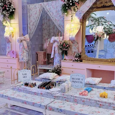 A "Become a Princess" pamper station, complete with personal vanities and a nail art bar. This interactive area was designed with floral fabrics and ornate mirrors to fit the royal theme.