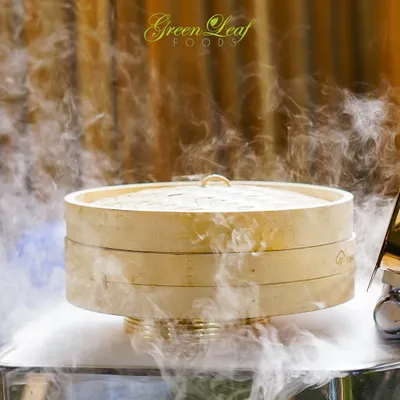 The drama of dry ice adds a touch of magic to this bamboo steamer. I use creative techniques like this to elevate the presentation of my dishes and create an unforgettable visual experience for your guests.