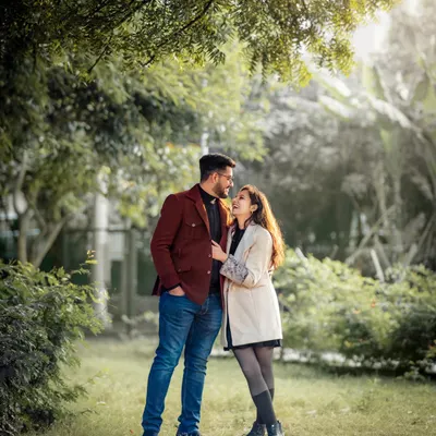 A quiet moment shared between a couple during their outdoor pre-wedding session. We used the soft, golden hour light filtering through the trees to create this warm, vintage feel, guiding them into a pose that feels both romantic and natural.