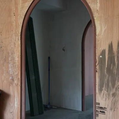 A work-in-progress view of the arches that became the boutique's signature feature. Even in their raw plywood state, the repeating curves begin to create the sense of depth and fluid movement that we envisioned for the space.