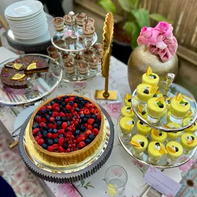 A dessert spread that promises pure indulgence. Featuring a fresh berry tart, individual tiramisu cups, and a zesty lemon soufflé, there's a sweet ending for every guest.