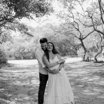 A moment of pure, unscripted laughter and joy between the parents-to-be. Black and white enhances the emotion, making this candid shot feel even more special.