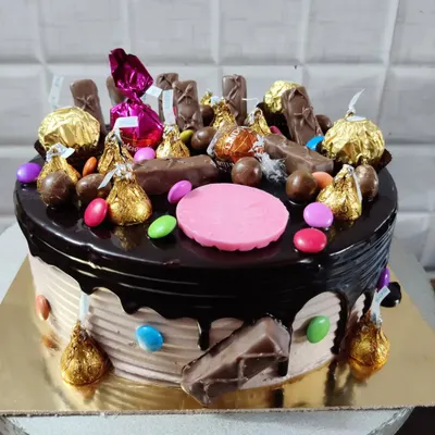 A chocolate overload cake that's pure indulgence. It's loaded with Ferrero Rocher, Hershey's Kisses, M&Ms, and a variety of other chocolates.
