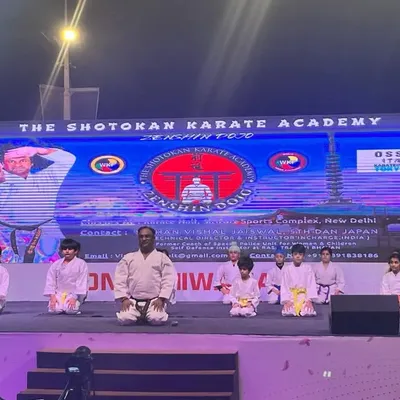 Taking a moment of formal respect (seiza) on stage with my students at the Konnichiwa Japan event. Discipline and respect are the first and last lessons in our dojo.