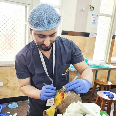This image captures me during a hands-on surgical workshop, honing my skills. Dermatosurgery requires immense focus and precision, whether it's a simple mole removal, a skin biopsy, or a more complex scar revision surgery.