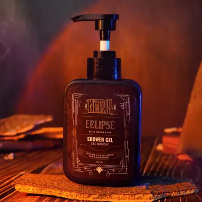 A moody, atmospheric shot of a shower gel bottle, using smoke and warm, dramatic lighting. This style of photography is excellent for creating a high-end, sophisticated brand identity.