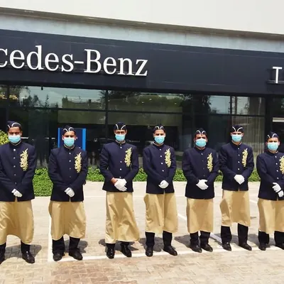 Our uniformed staff prepared to welcome guests at a corporate event for Mercedes-Benz. Our team's professionalism and attention to detail ensure a seamless experience that upholds the standards of luxury brands.
