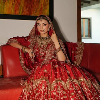 A bride seated like royalty. This classic red lehenga by Akriti by Shakun, paired with heavy traditional jewellery from Shri Paramanijewels, creates a powerful and timeless bridal portrait.