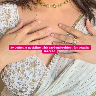 For a touch of glamour, a sweetheart neckline with zari embroidery is a timeless choice. It pairs beautifully with this sequin saree, creating a look that's perfect for a wedding or reception.