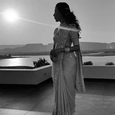 A beautiful silhouette of my client against the setting sun. The elegant drape of her saree creates a timeless and romantic memory of her engagement day.