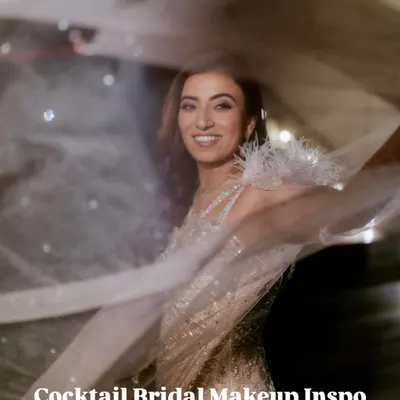 This is how you do cocktail glam. Retro waves, soft color shimmer, and an ivory cape moment that turns every head in the room. This look is glamorous yet effortless.