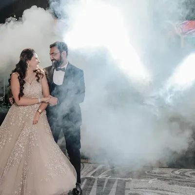 The couple's grand entrance for their first dance, surrounded by dramatic smoke. A truly cinematic moment from their cocktail night.