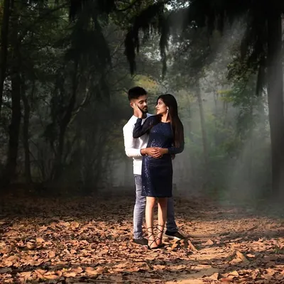 A romantic couple's portrait set in a misty, atmospheric forest. I use natural light and dramatic settings like this to create cinematic and memorable pre-wedding photographs.