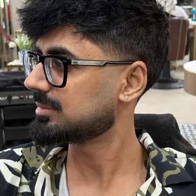 This is a side profile of a perfectly sculpted Italian beard. Notice the clean, sharp lines along the cheek and neckline, which define the jaw and give a strong, polished appearance.