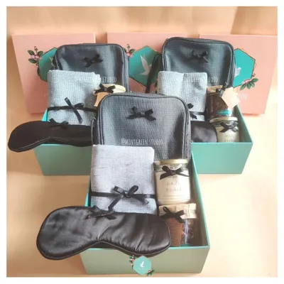 Appreciating a team with matching hampers. These boxes include a travel pouch, a soft towel, a scented candle, and an eye mask, perfect for helping them unwind after a big project.
