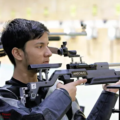 The intense focus of a young rifle shooter lining up his shot. We teach the breathing techniques, posture, and mental calmness required for precision shooting.