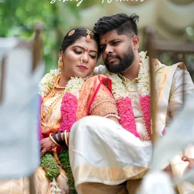 A tender moment between the bride and groom during their South Indian wedding ceremony. The soft focus and natural setting add to the romance of the shot.
