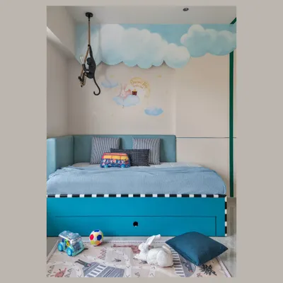 It's all about the small details in a kids' room. This space features a whimsical cloud mural, a fun monkey-shaped lamp, and a cozy daybed with plenty of hidden storage for toys.