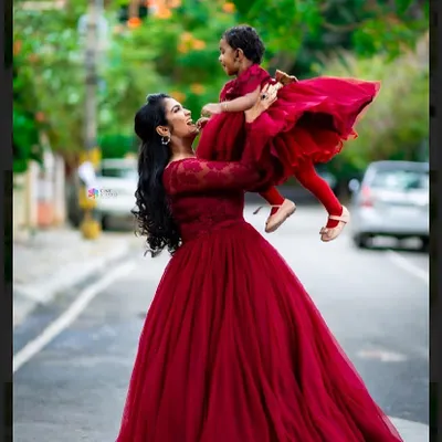 A heartwarming mother-daughter portrait. I styled them in matching deep red gowns, creating a beautiful visual connection that celebrates their bond.