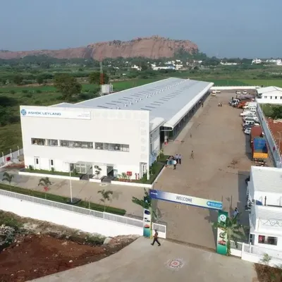 An aerial view of the TVS Mobility - Ashok Leyland factory in Kodikulam, showcasing the facility's extensive footprint and organized layout. The design facilitates seamless entry, service, and exit for heavy vehicles, crucial for a logistics hub.
