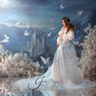 A fairytale maternity portrait created with digital art. The expecting mother stands in a white gown before a majestic castle, surrounded by cherry blossoms and butterflies.