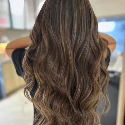 A perfect example of a total hair transformation. I gave her a long layered haircut and used a back-to-back foil technique to create these blended, three-tone highlights for a completely new and vibrant look.